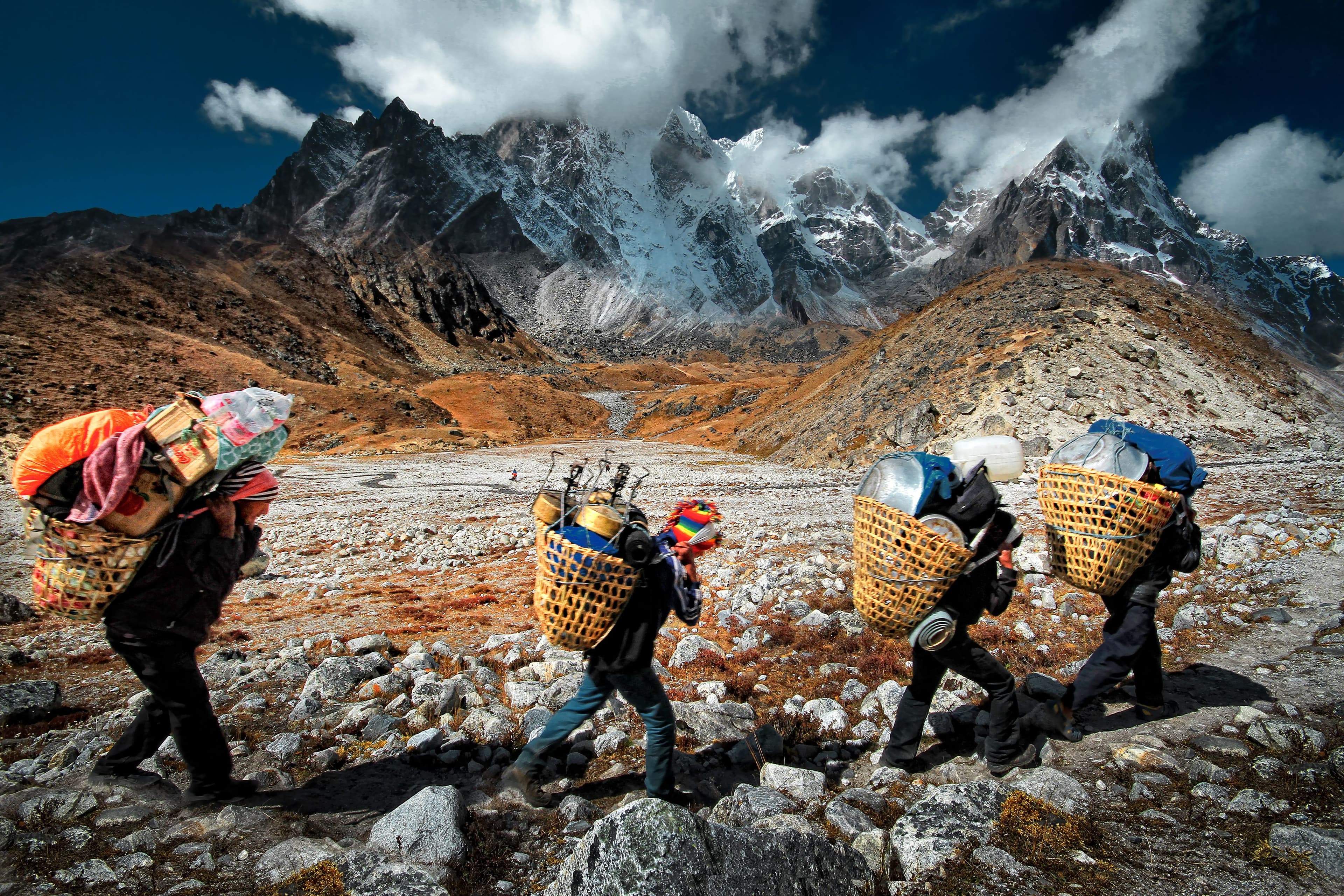 Volunteers collecting litter on a grassy mountainside